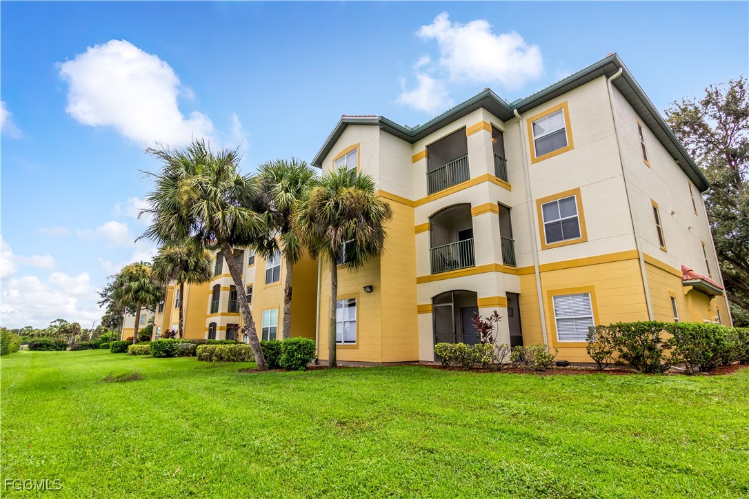 11490 Villa Grand, Unit 224 Fort Myers, FL 33913 - Photo 25 of 30 a front view of multi story residential apartment building with yard and green space
