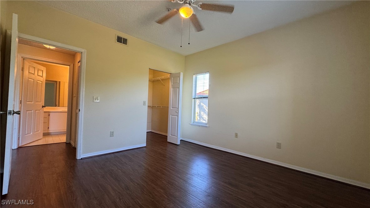 11490 Villa Grand, Unit 224 Fort Myers, FL 33913 - Photo 26 of 30 a view of an empty room with wooden floor and a window
