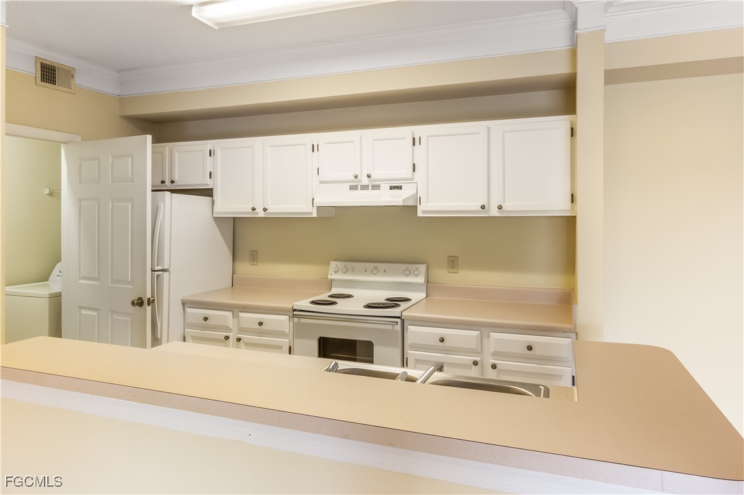 11490 Villa Grand, Unit 224 Fort Myers, FL 33913 - Photo 28 of 30 a kitchen with stainless steel appliances a stove a sink and white cabinets