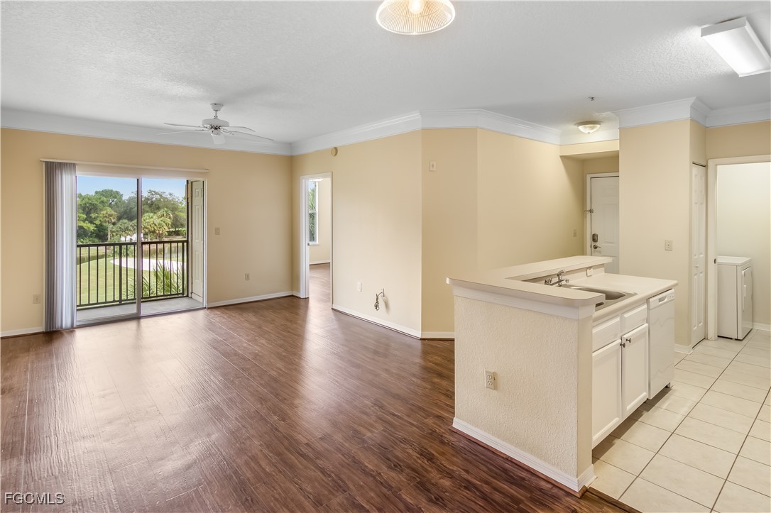 11490 Villa Grand, Unit 224 Fort Myers, FL 33913 - Photo 3 of 30 a kitchen that has a lot of white cabinets and wooden floor