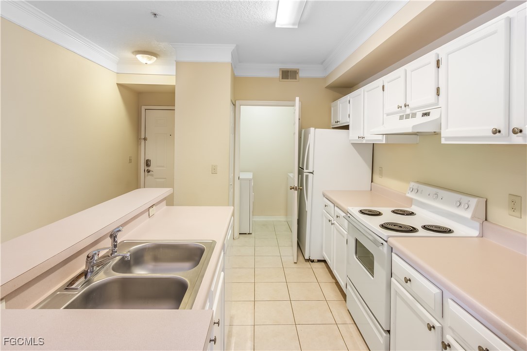 11490 Villa Grand, Unit 224 Fort Myers, FL 33913 - Photo 7 of 30 a kitchen with a sink stove and refrigerator