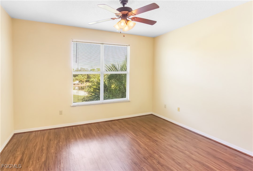 11490 Villa Grand, Unit 224 Fort Myers, FL 33913 - Photo 9 of 30 an empty room with a window and a ceiling fan