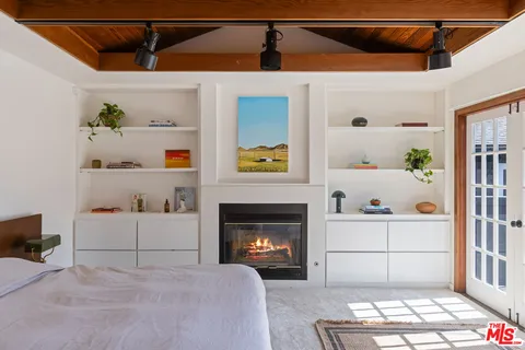 a white bed sitting in a kitchen next to a window