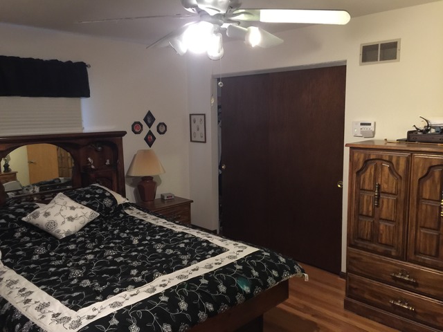 16253 South River Road Plainfield, IL 60586 - Photo 14 of 14 a bedroom with bed and wooden floor