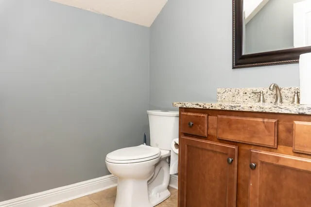 a bathroom with a toilet and a mirror