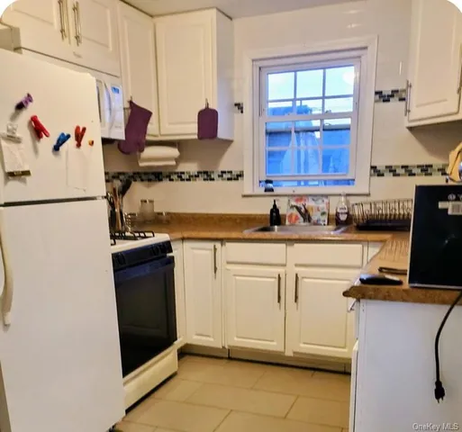 a kitchen with a refrigerator and a sink