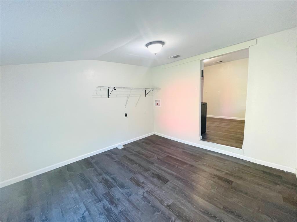 111 Rousseau Street Waxahachie, TX 75165 - Photo 10 of 22 a view of an empty room with wooden floor and a window