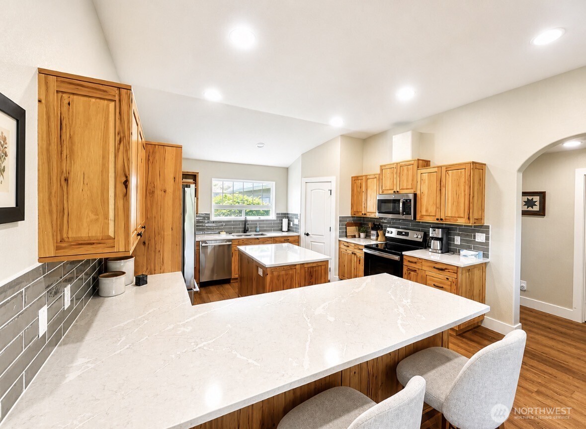 22 Rooster Flats Road Oroville, WA 98844 - Photo 12 of 28 a large kitchen with a large window and stainless steel appliances