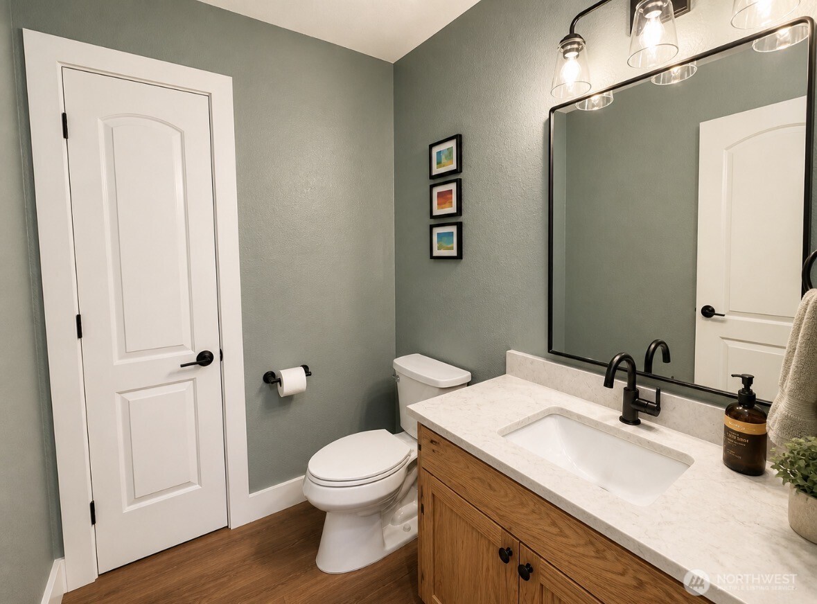 22 Rooster Flats Road Oroville, WA 98844 - Photo 16 of 28 a bathroom with a toilet a sink and wooden floor