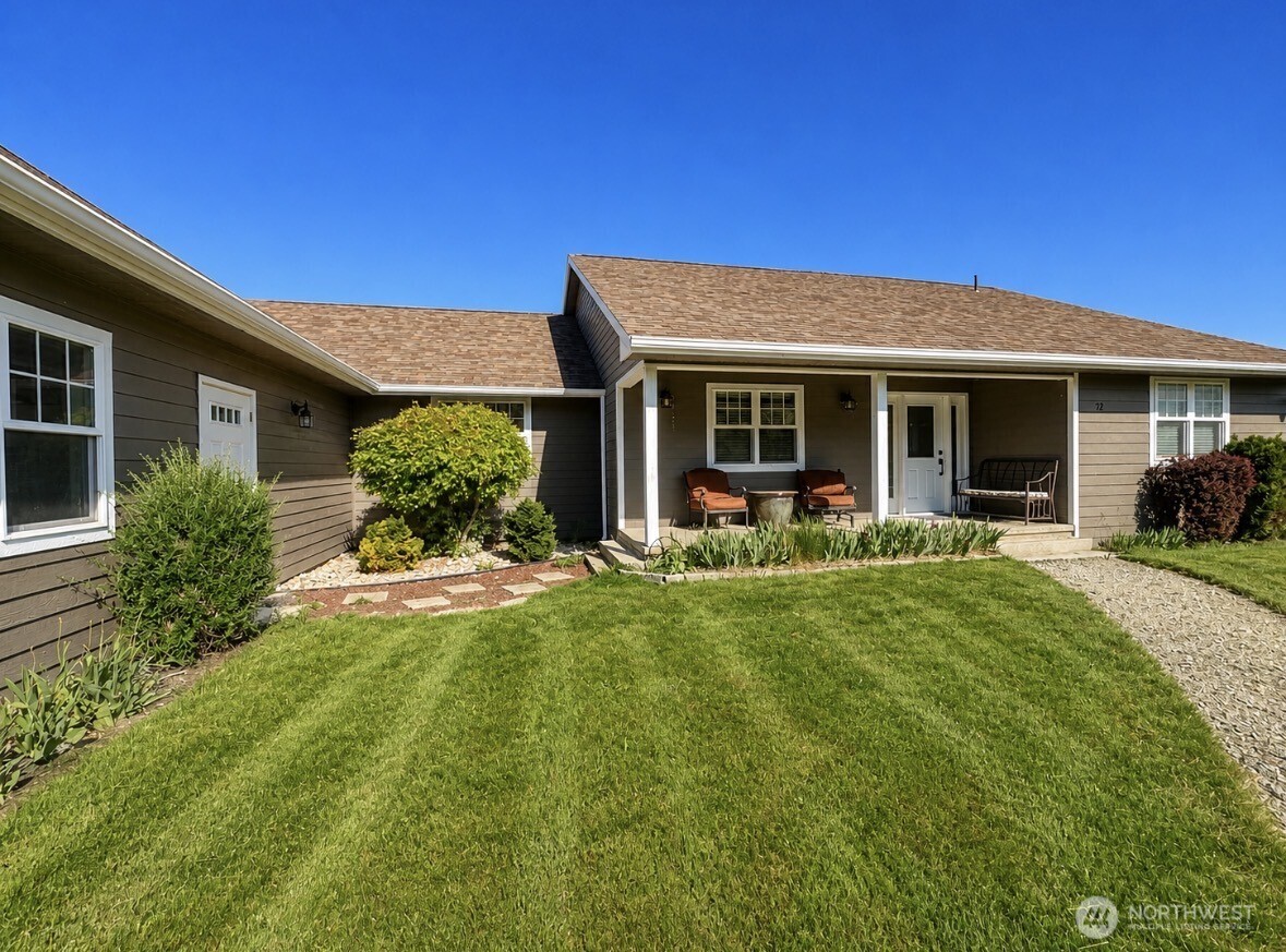22 Rooster Flats Road Oroville, WA 98844 - Photo 2 of 28 a view of a house with a yard patio and a small yard