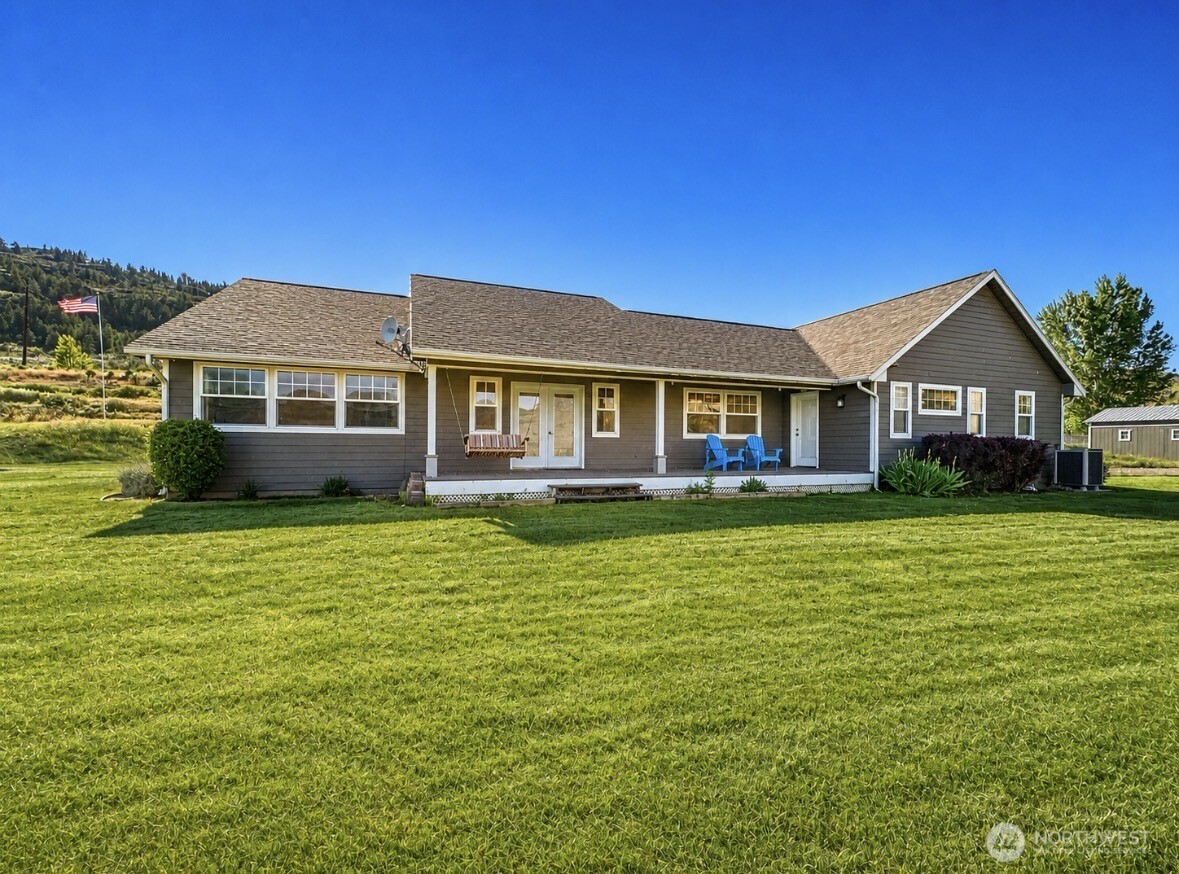 22 Rooster Flats Road Oroville, WA 98844 - Photo 3 of 28 a front view of a house with a garden