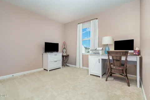 a view of a workspace with furniture and a flat screen tv