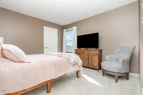 a bedroom with bed and tv