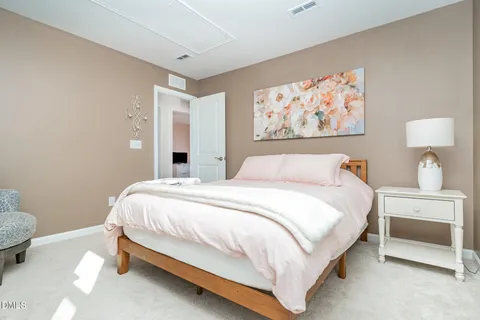 a bedroom with a bed and a painting on the wall