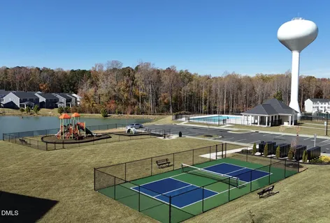 a view of a swimming pool with a patio and a yard