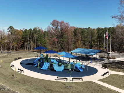 a swimming pool with outdoor seating and yard in the back