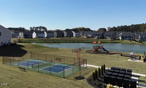 a view of a lake with a table and chairs