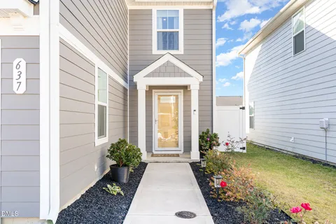a view of a house with potted plants