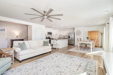 a living room with furniture and kitchen view