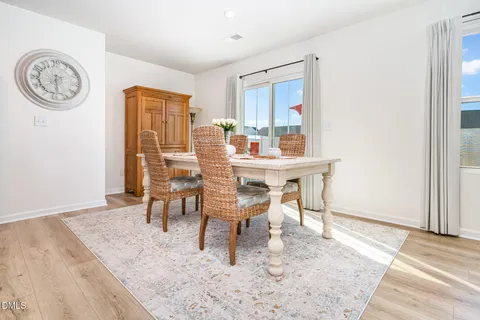 a dining room with furniture and wooden floor