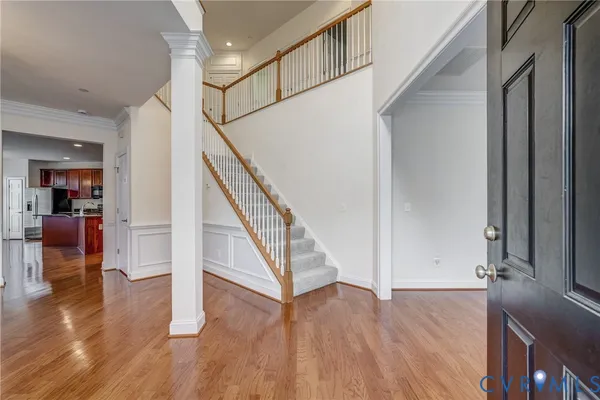 a spacious bathroom with a granite countertop double vanity sink a mirror and a bathtub