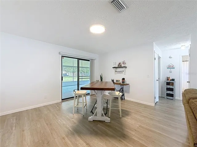 a dining room with furniture and wooden floor