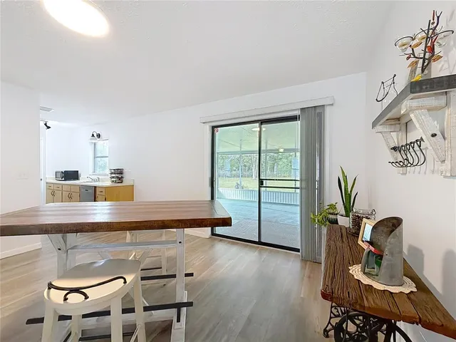 a view of a kitchen with workspace and wooden floor