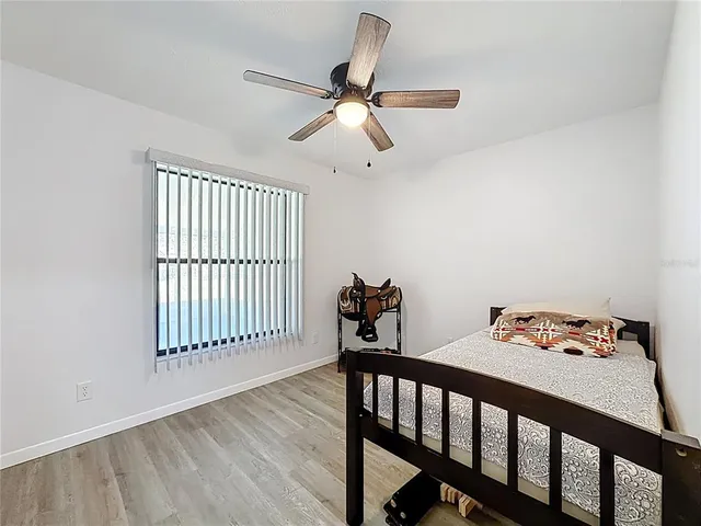 a view of a room with furniture and wooden floor