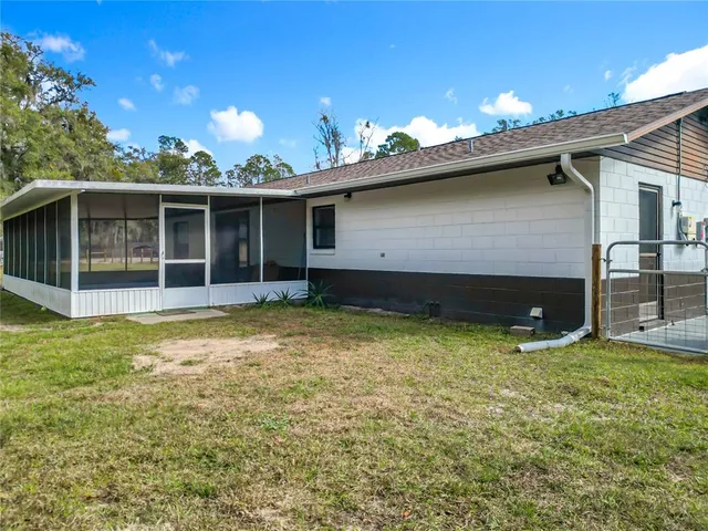 a backyard of a house with yard and outdoor seating