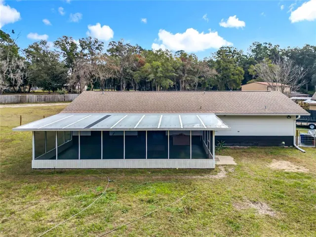 a view of a house with swimming pool and a yard