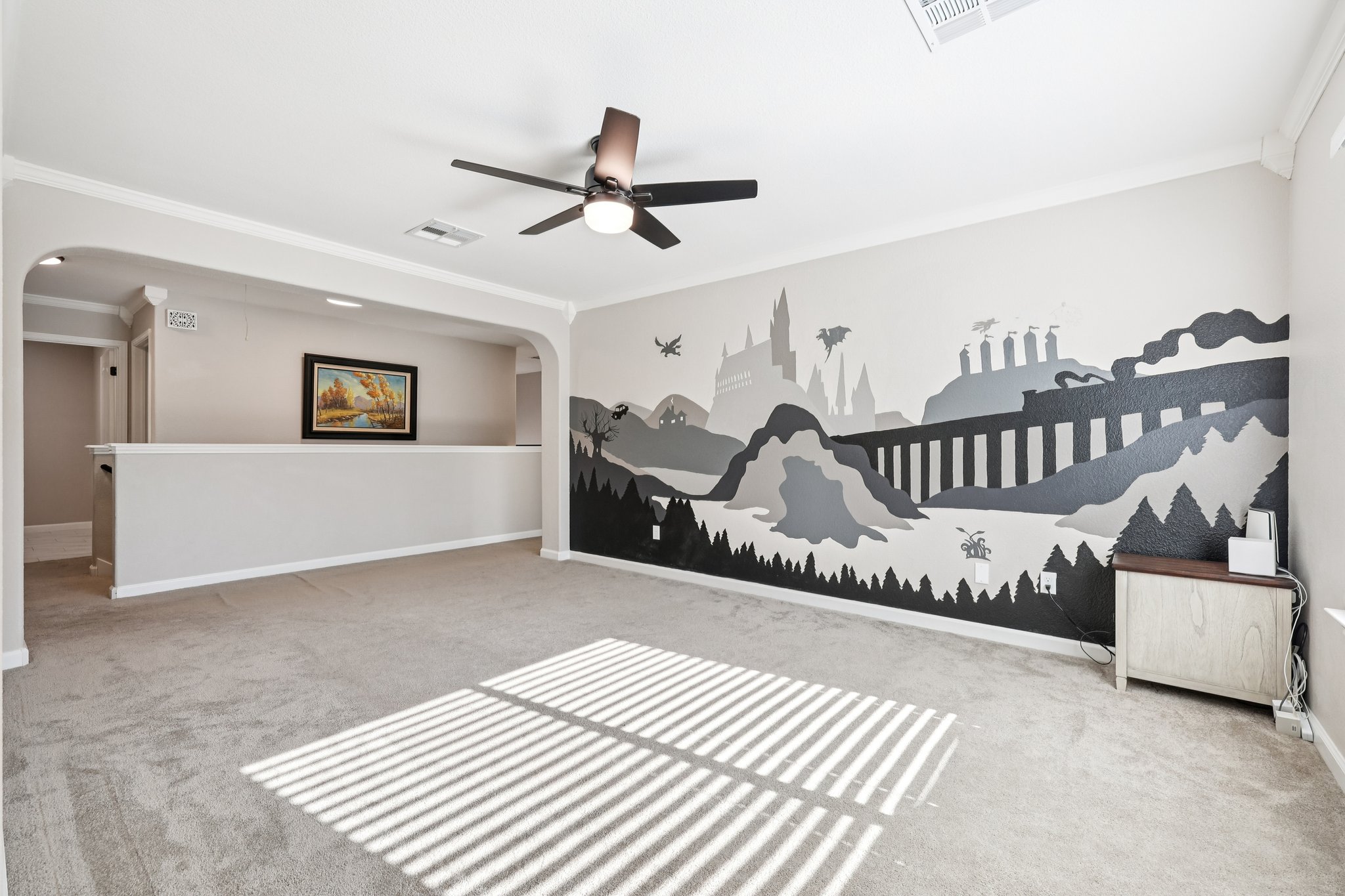 12717 Machete Trail Austin, TX 78729 - Photo 12 of 32 Unfurnished bedroom featuring crown molding, light colored carpet, arched walkways, and ceiling fan