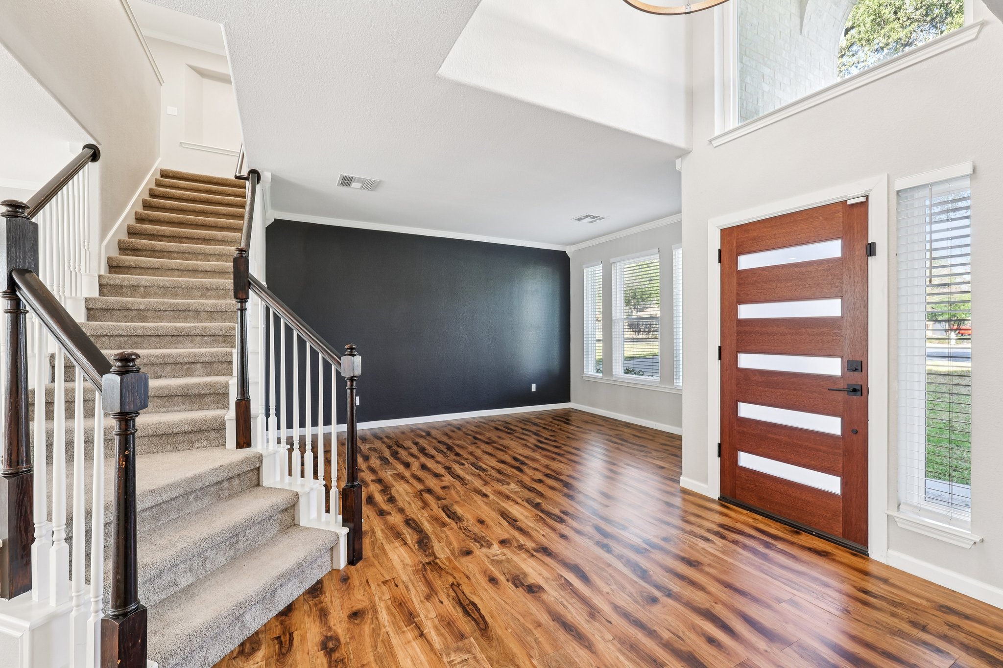 12717 Machete Trail Austin, TX 78729 - Photo 2 of 32 Entryway with wood finished floors, crown molding, and stairway