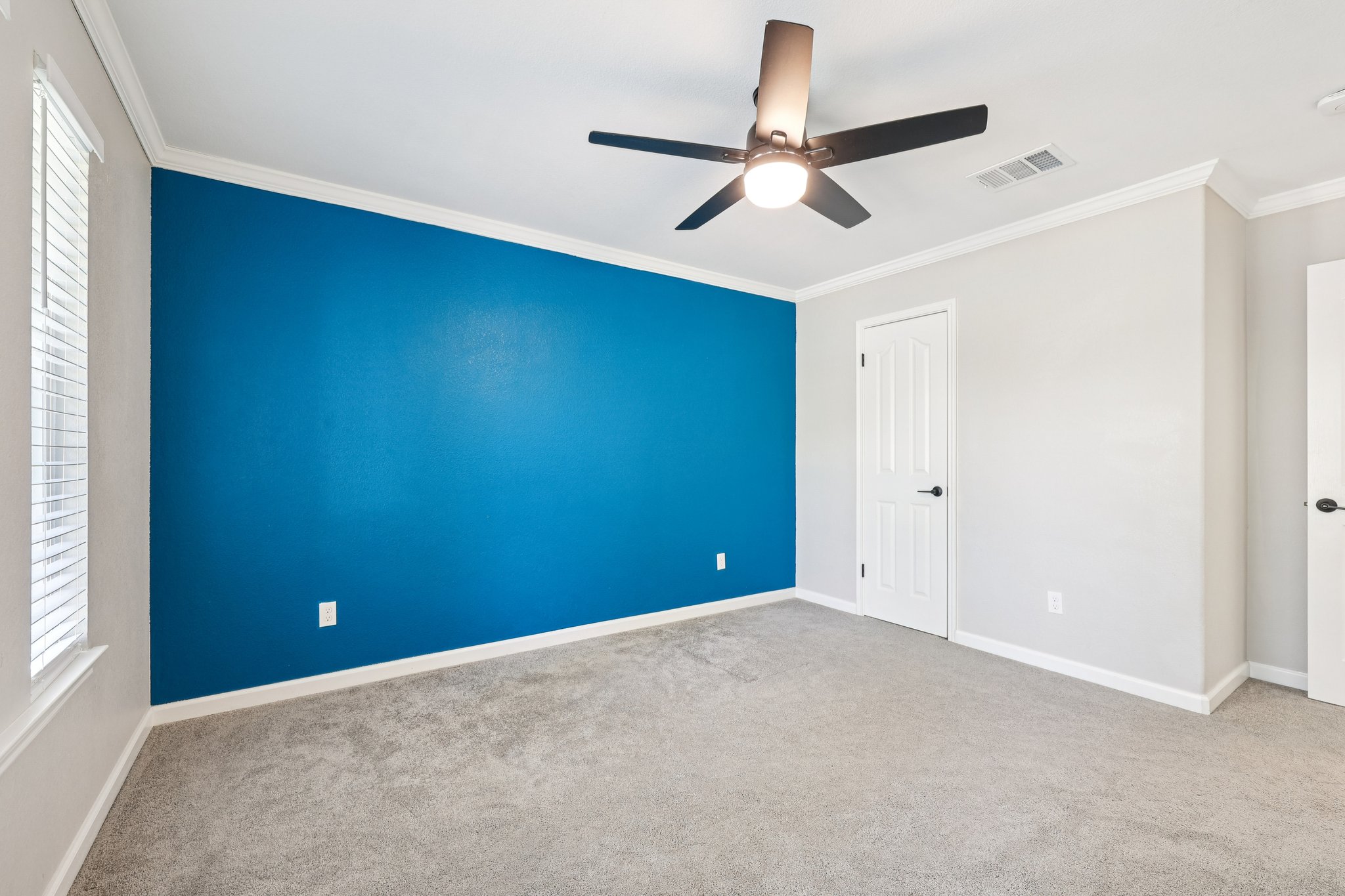 12717 Machete Trail Austin, TX 78729 - Photo 22 of 32 Unfurnished bedroom featuring ornamental molding, carpet floors, and a ceiling fan