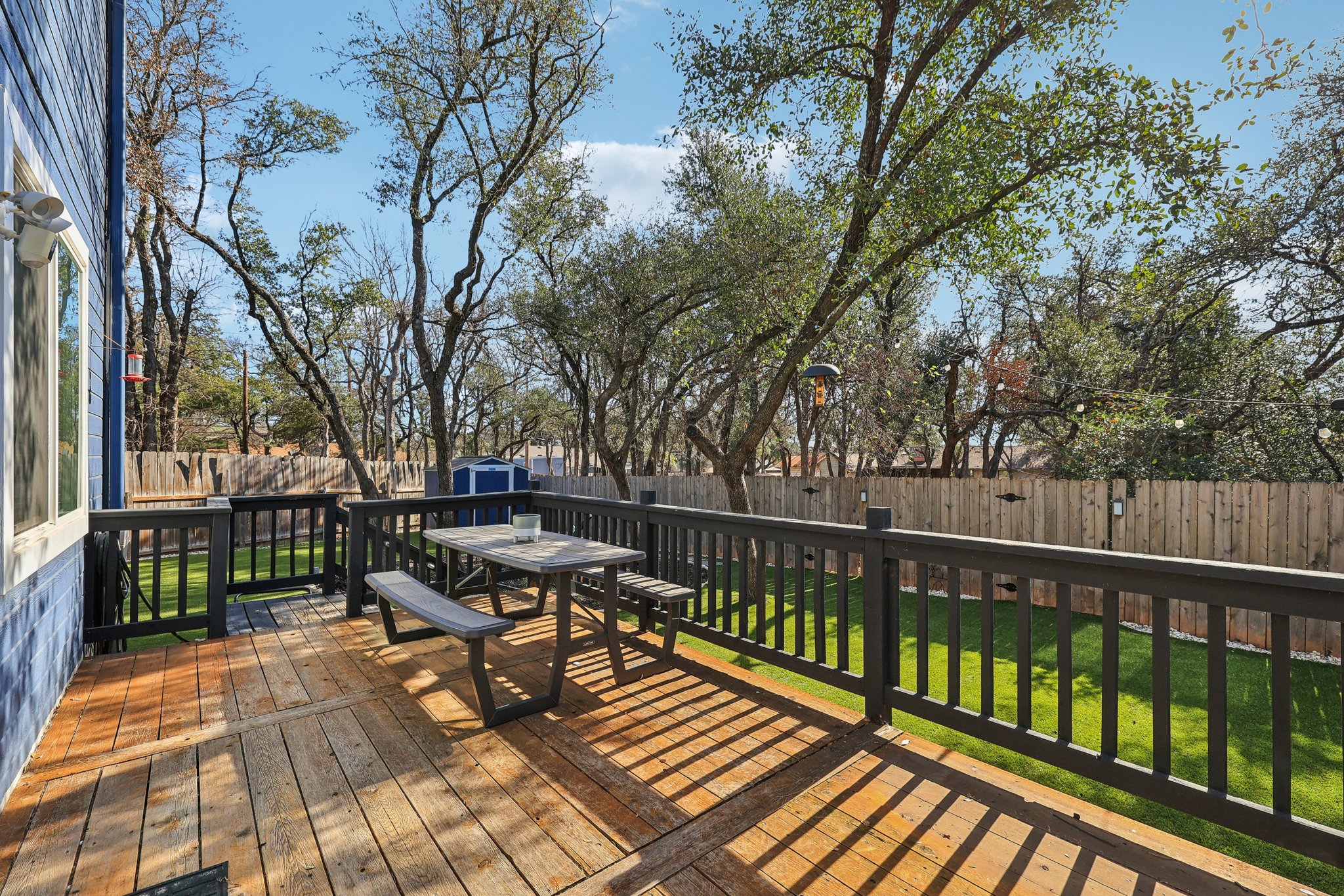 12717 Machete Trail Austin, TX 78729 - Photo 25 of 32 Wooden deck featuring a fenced backyard, a storage unit, and outdoor dining area