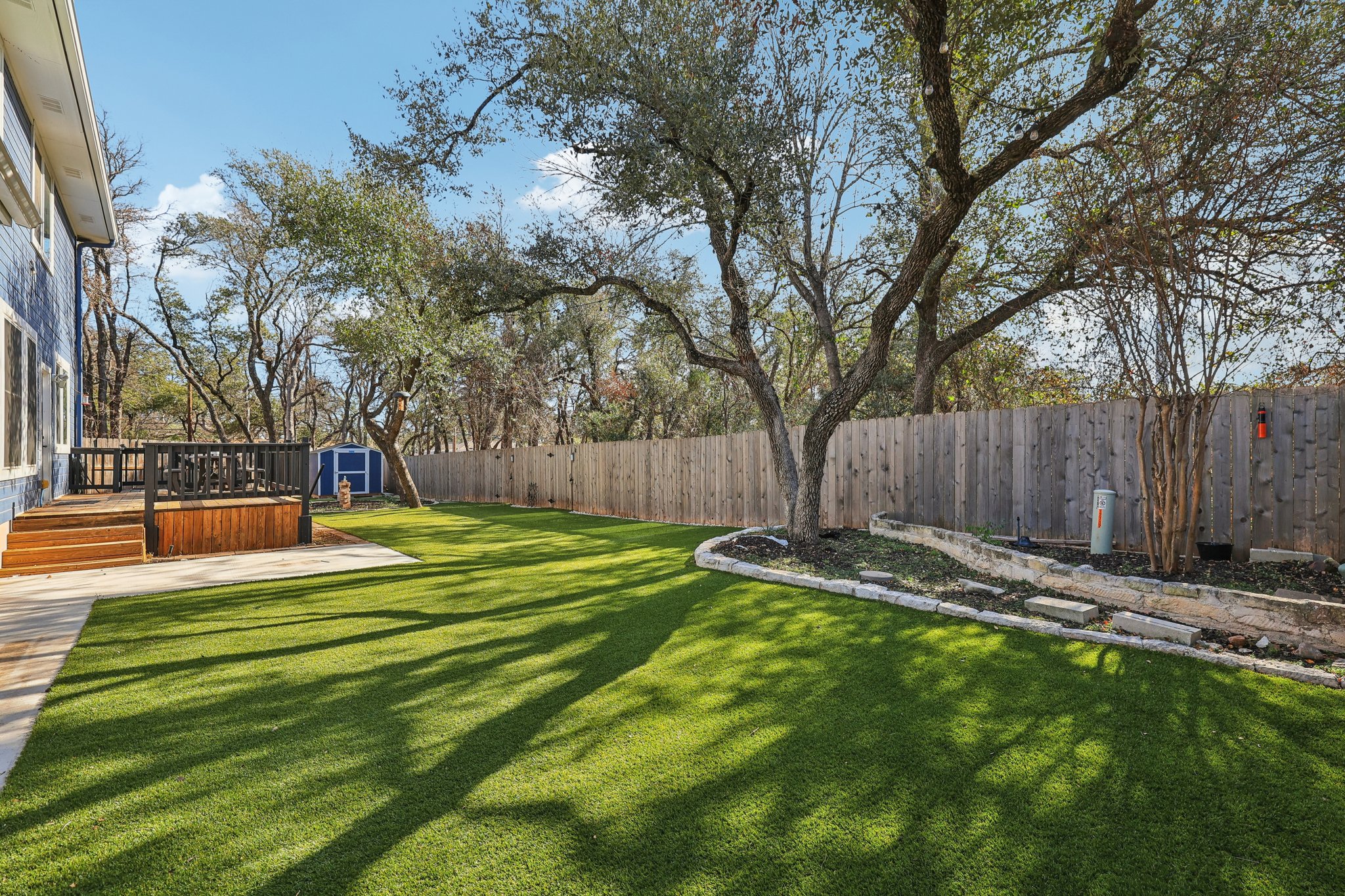 12717 Machete Trail Austin, TX 78729 - Photo 27 of 32 Fenced backyard with a wooden deck