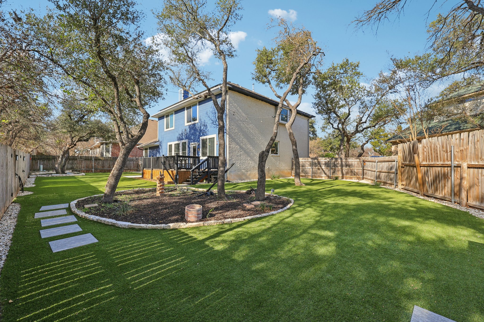 12717 Machete Trail Austin, TX 78729 - Photo 28 of 32 Back of property with a fenced backyard and a wooden deck