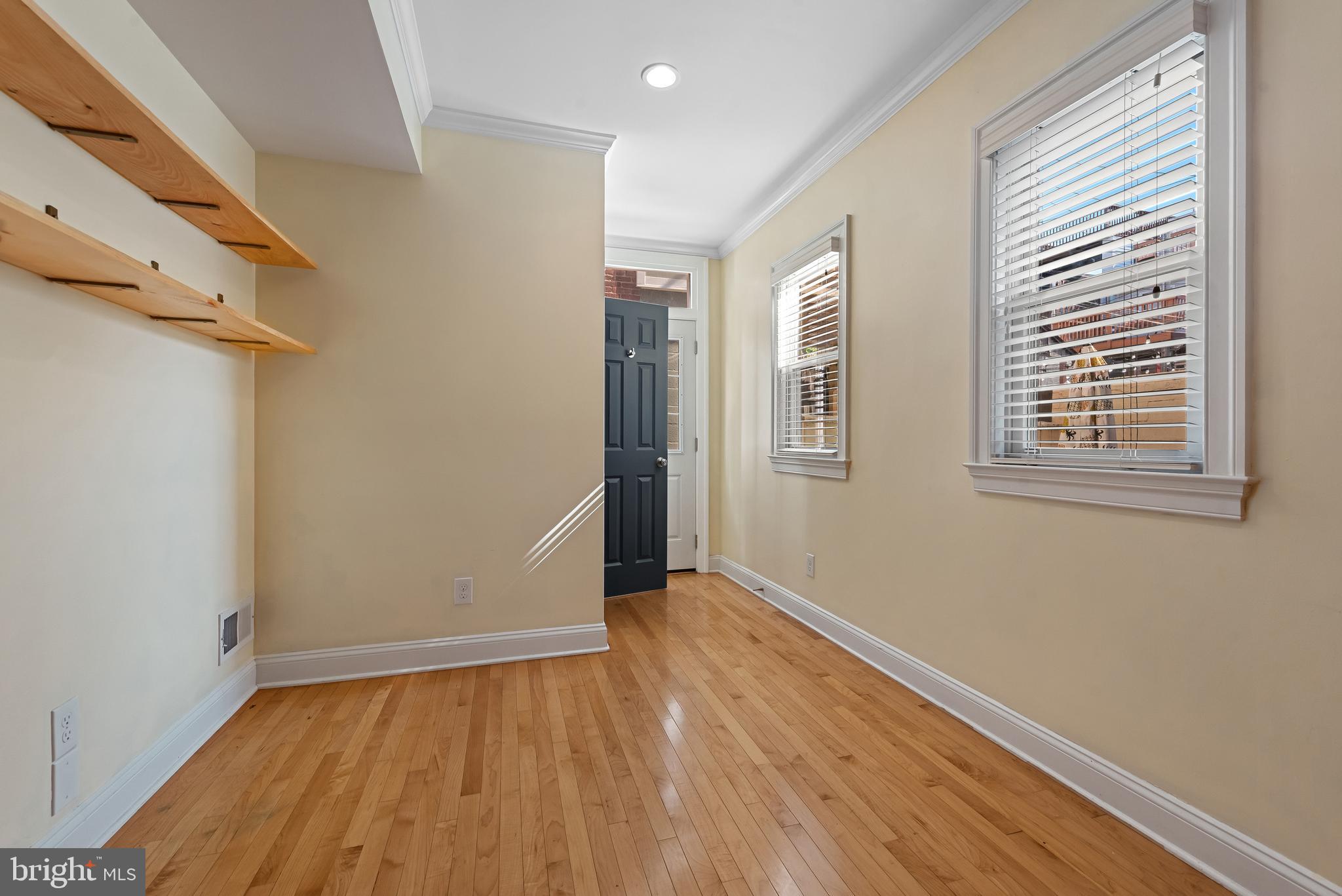 3006 Dillon Street Baltimore, MD 21224 - Photo 11 of 27 an empty room with wooden floor and windows