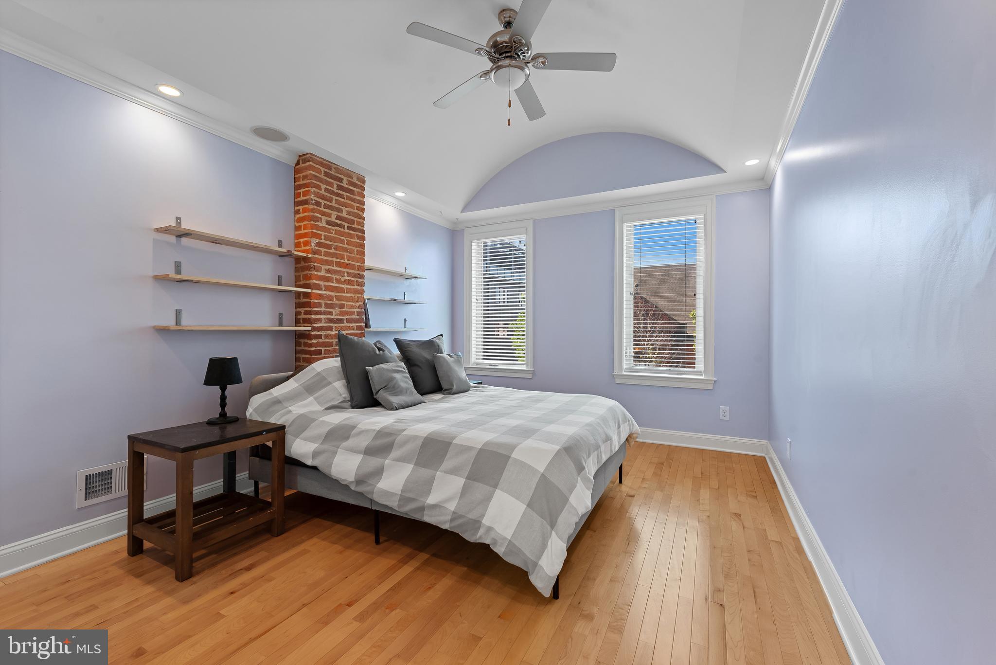 3006 Dillon Street Baltimore, MD 21224 - Photo 14 of 27 a bedroom with a bed and wooden floor