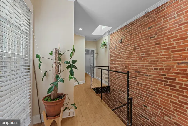 a view of a balcony with chairs potted plants and wooden floor