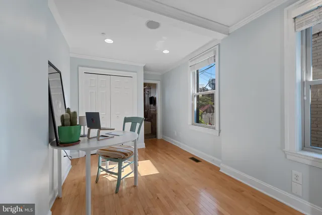 a workspace room with furniture and wooden floor