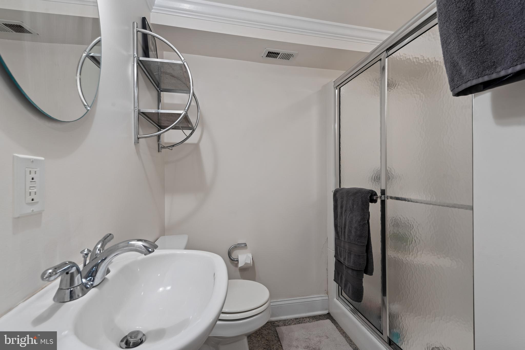 3006 Dillon Street Baltimore, MD 21224 - Photo 26 of 27 a bathroom with a sink toilet and shower