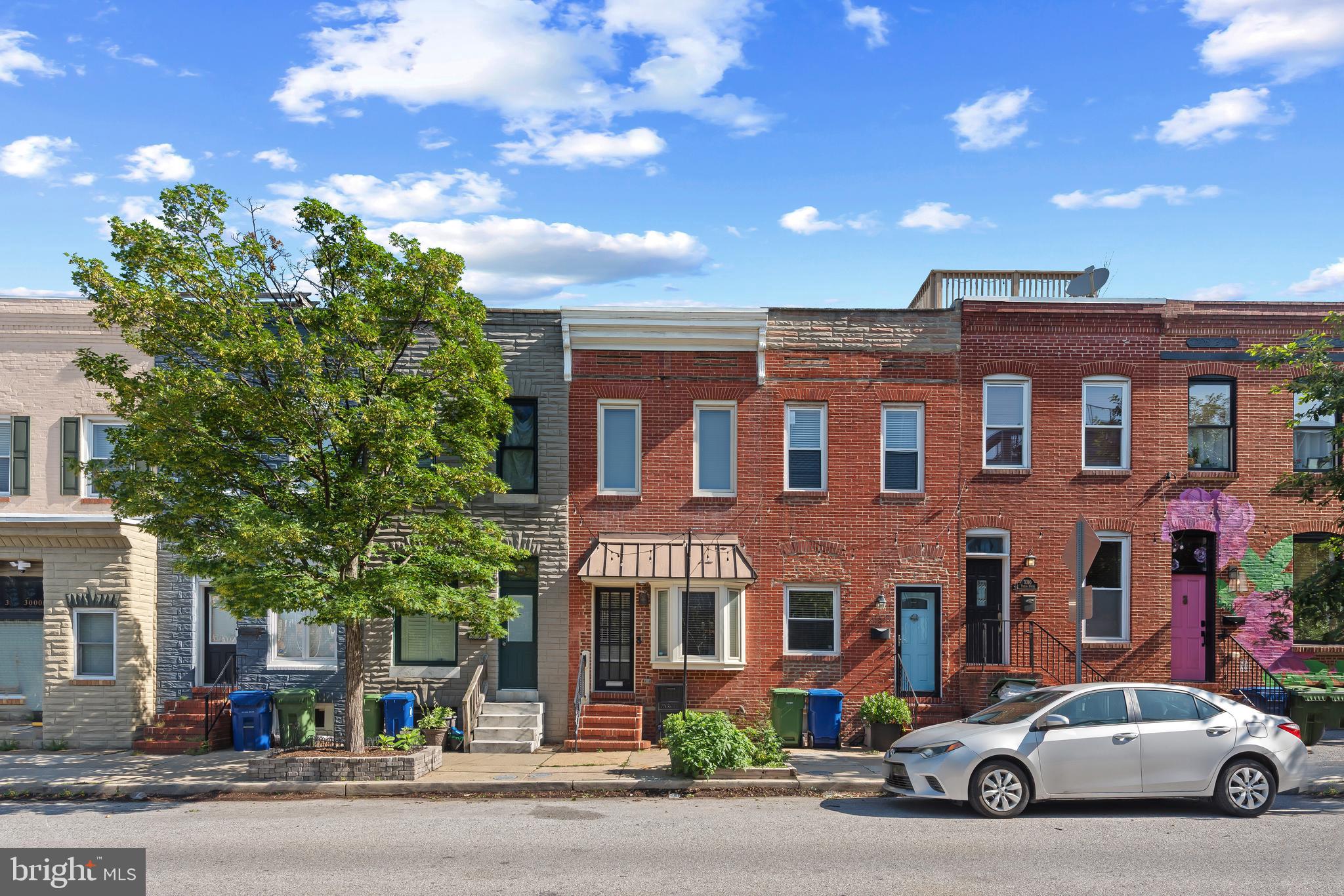3006 Dillon Street Baltimore, MD 21224 - Photo 5 of 27 front view of a brick house with a street