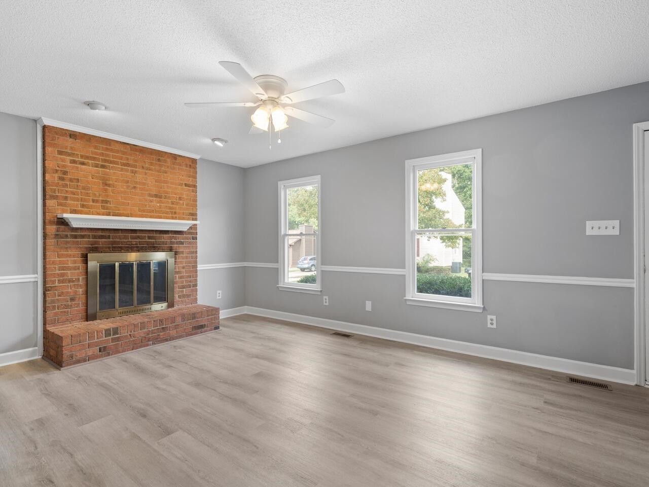 3608 Iron Sight Court Raleigh, NC 27616 - Photo 3 of 36 an empty room with windows fireplace and fan