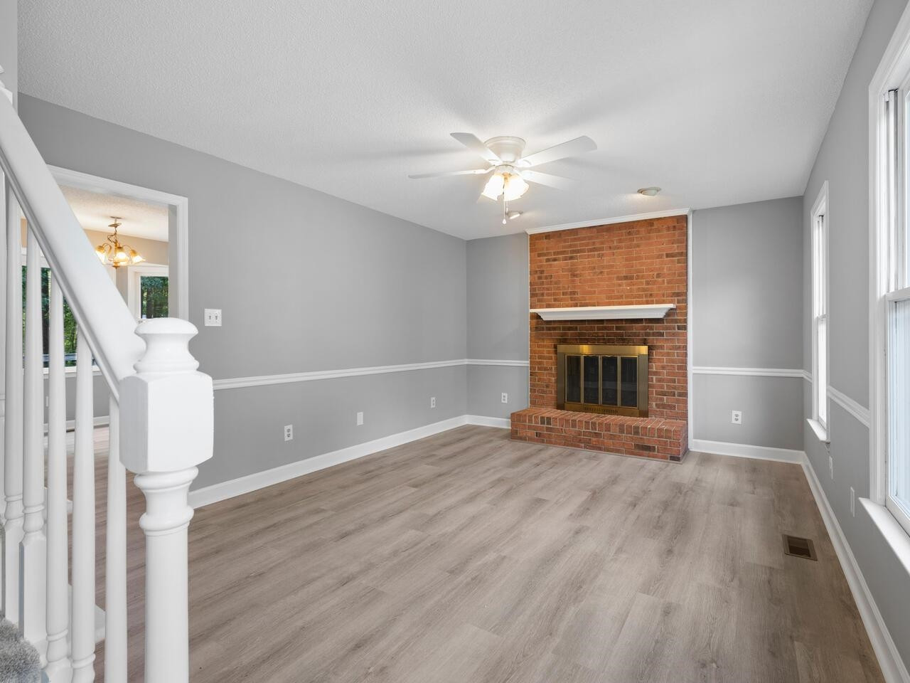 3608 Iron Sight Court Raleigh, NC 27616 - Photo 5 of 36 a view of empty room with wooden floor and fireplace