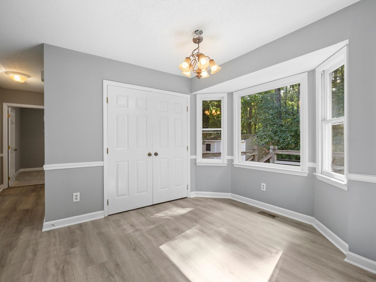 3608 Iron Sight Court Raleigh, NC 27616 - Photo 10 of 36 wooden floor in an empty room with a window