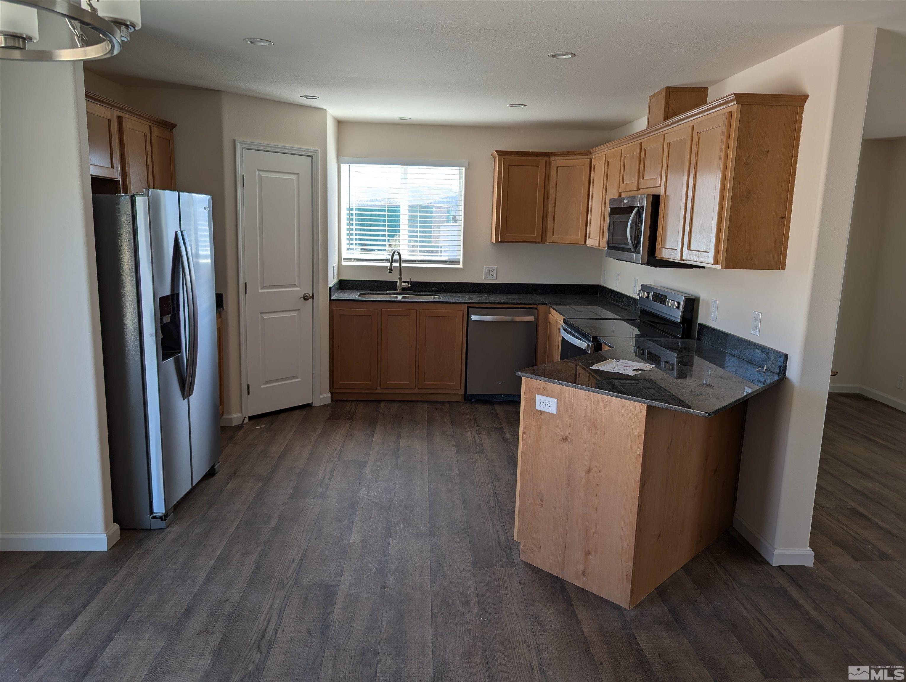 520 Matterhorn Boulevard Reno, NV 89506 - Photo 6 of 11 a kitchen with a refrigerator sink and wooden floor