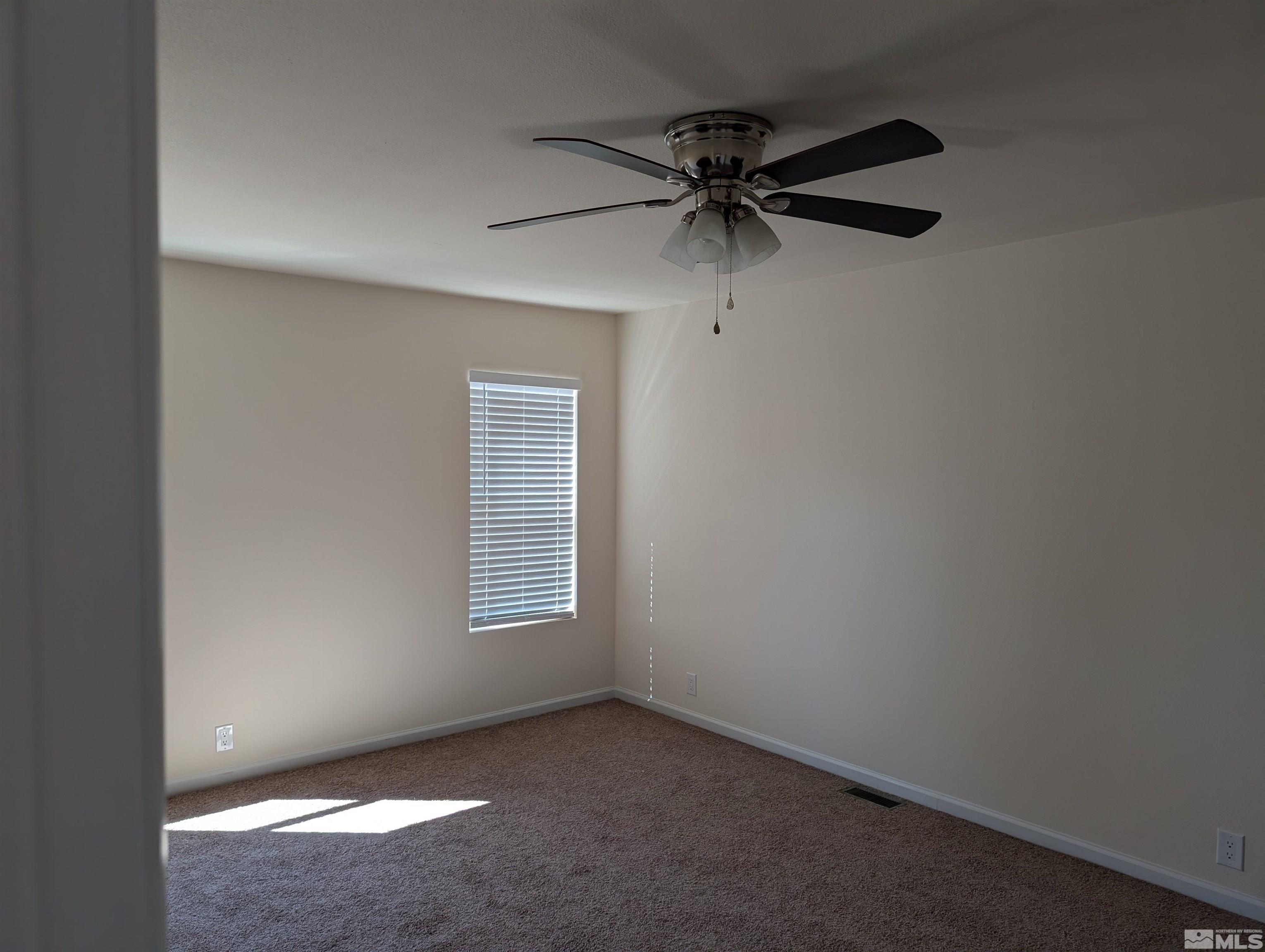 520 Matterhorn Boulevard Reno, NV 89506 - Photo 9 of 11 an empty room with a window and a fan