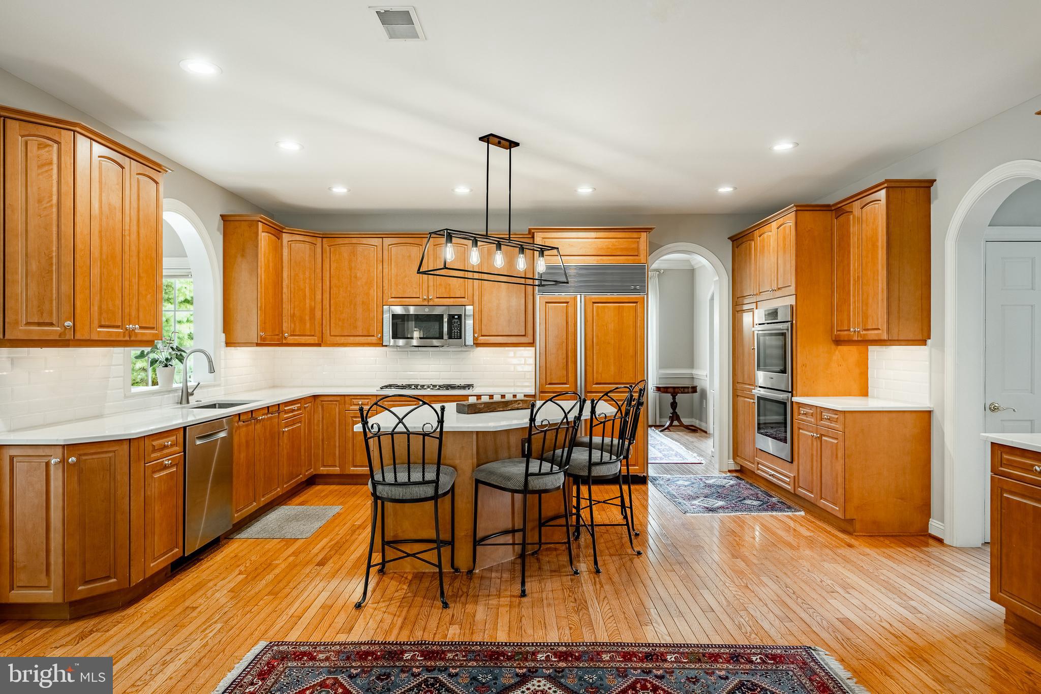 37 Ruth Circle Malvern, PA 19355 - Photo 19 of 63 a kitchen with stainless steel appliances granite countertop wooden floor a dining table and chairs