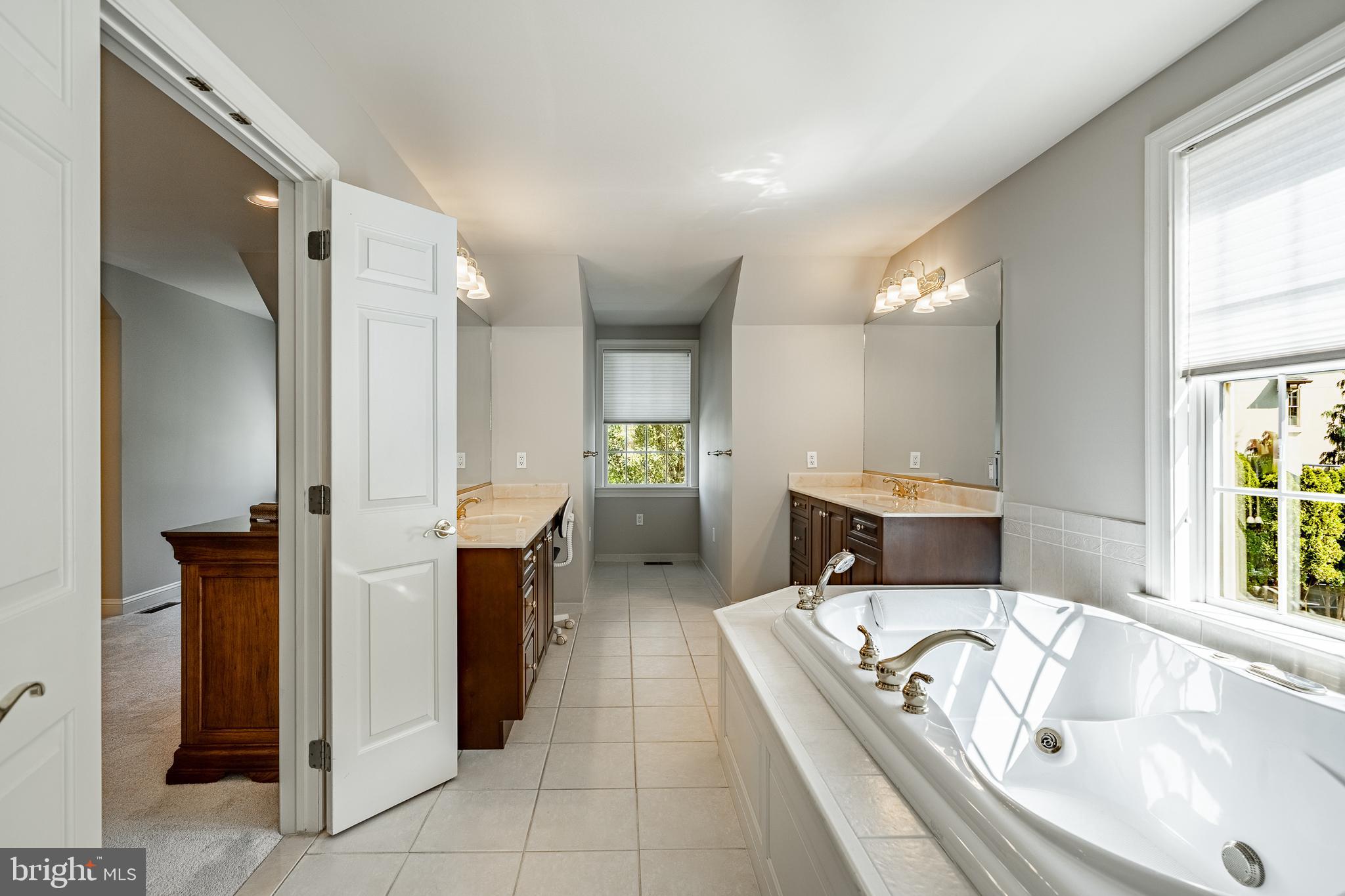 37 Ruth Circle Malvern, PA 19355 - Photo 37 of 63 a bathroom with a tub a double vanity sink and mirror