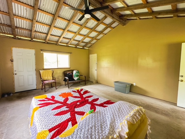 11-3239 4th Street Volcano, HI 96785 - Photo 5 of 22 a bedroom with a bed and wooden floor